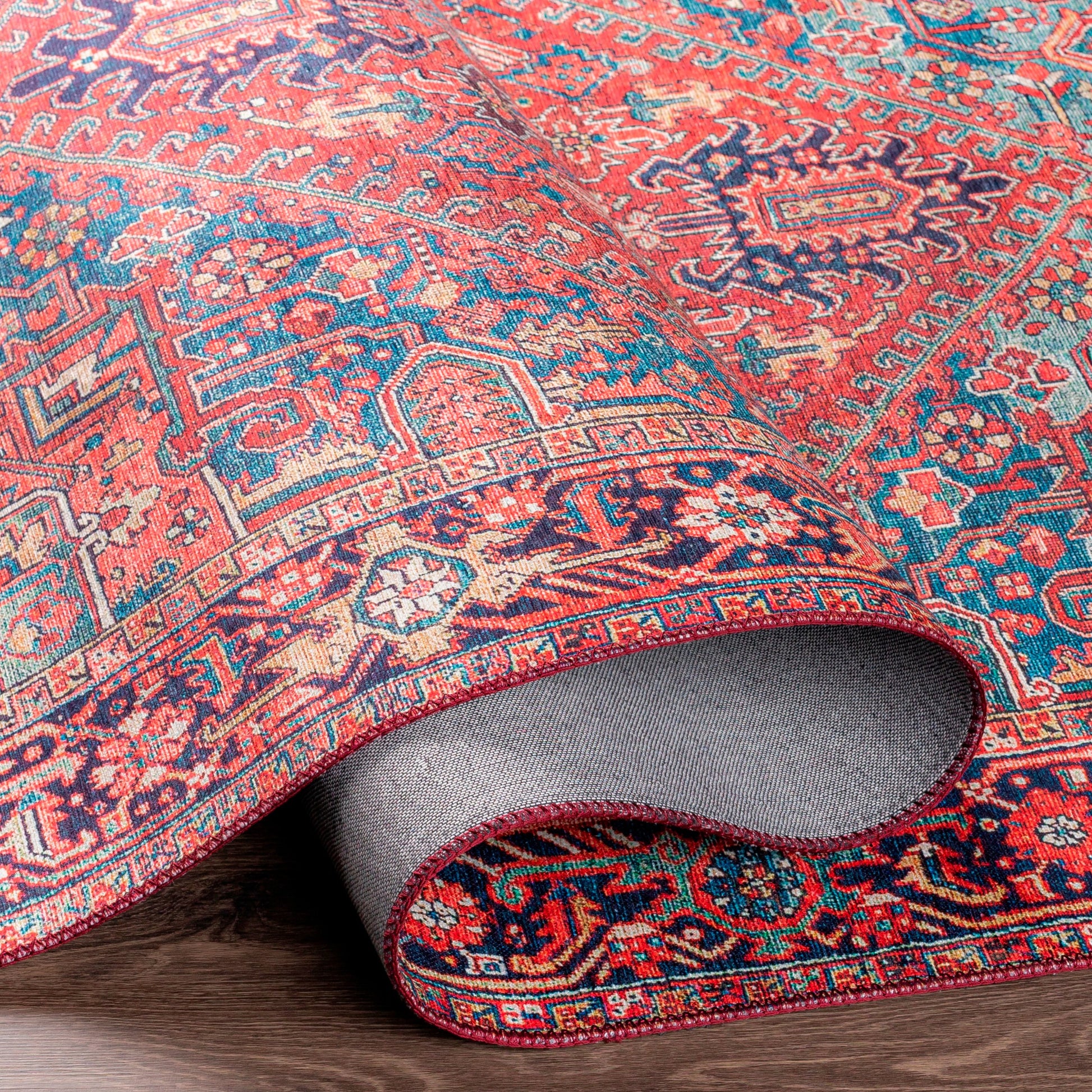 Iris Rug by Livabliss in dark blue, red, tan, teal, cream. Made from 100% polyester in a traditional style.