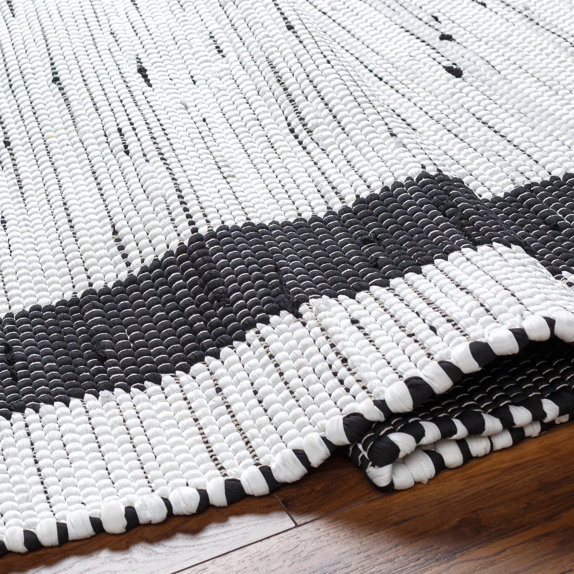 Jean Rug - 32471 by Livabliss in ivory, black. Made from main: 100% recycled fabric in a unique style.