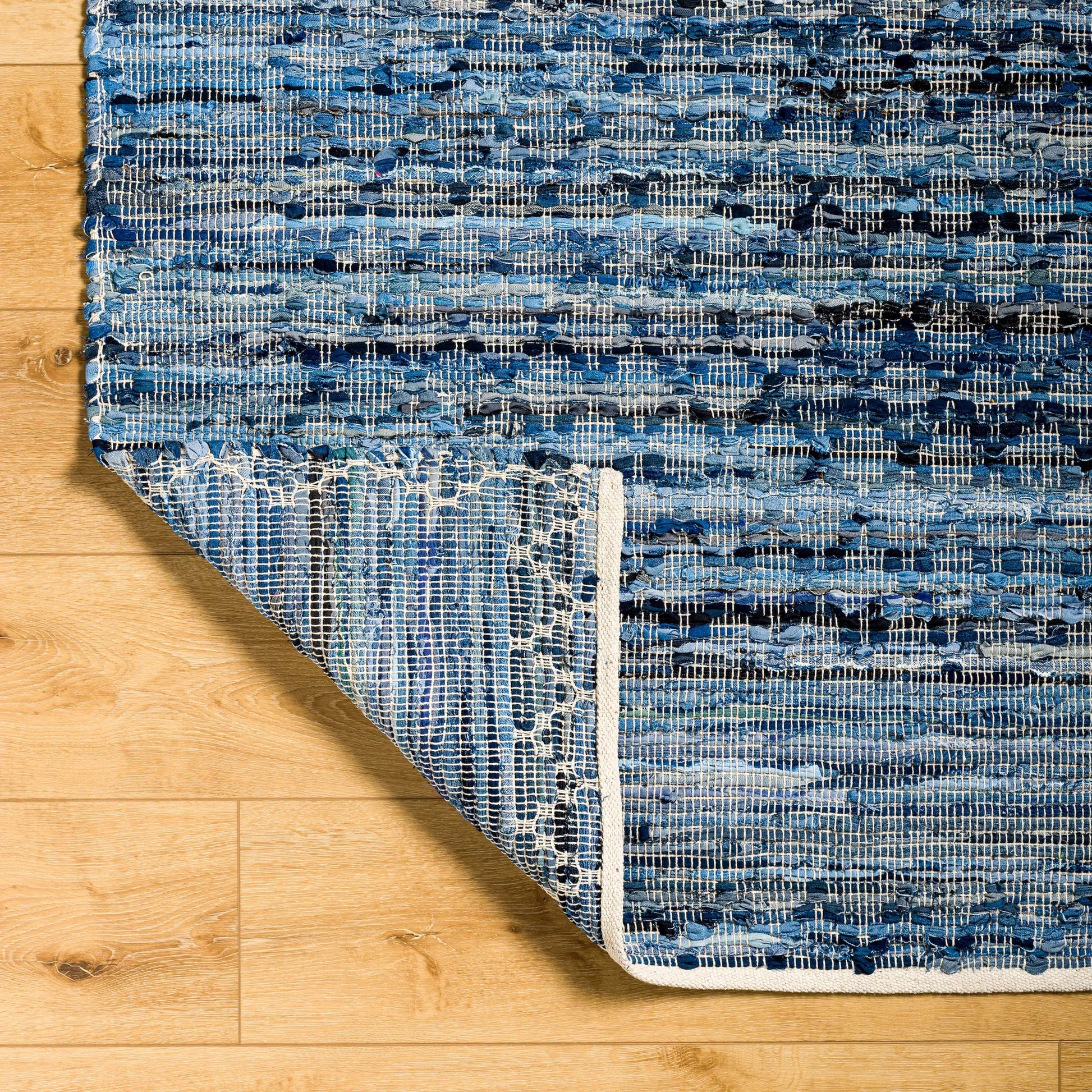 Jean Rug - 32476 by Livabliss in denim blue, slate gray, charcoal, sky blue, steel blue. Made from main: 100% recycled fabric in a unique style.