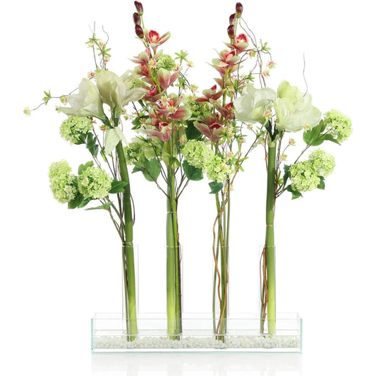 Changing Florals 1 by John-Richard in green, white, pink, gold. Made from snowballs, amaryllis, cymbidium orchids, natural curly willow, wildflowers, wire, faux water, glass in a unique style.