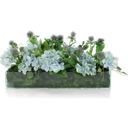 English Garden by John-Richard in blue, green, clear. Made from eucalyptus leaves, hydrangeas, thistle, glass, reindeer moss in a transitional style.