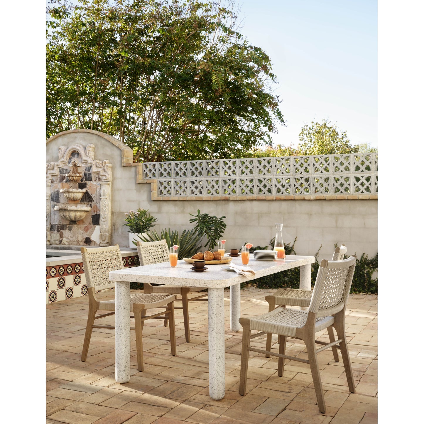 017 SR-809858 | Lifestyle | Delmar Outdoor Dining Chair by Four Hands. Made from solid fsc®-certified teak, 100% polypropylene in a cottage & farmhouse style.