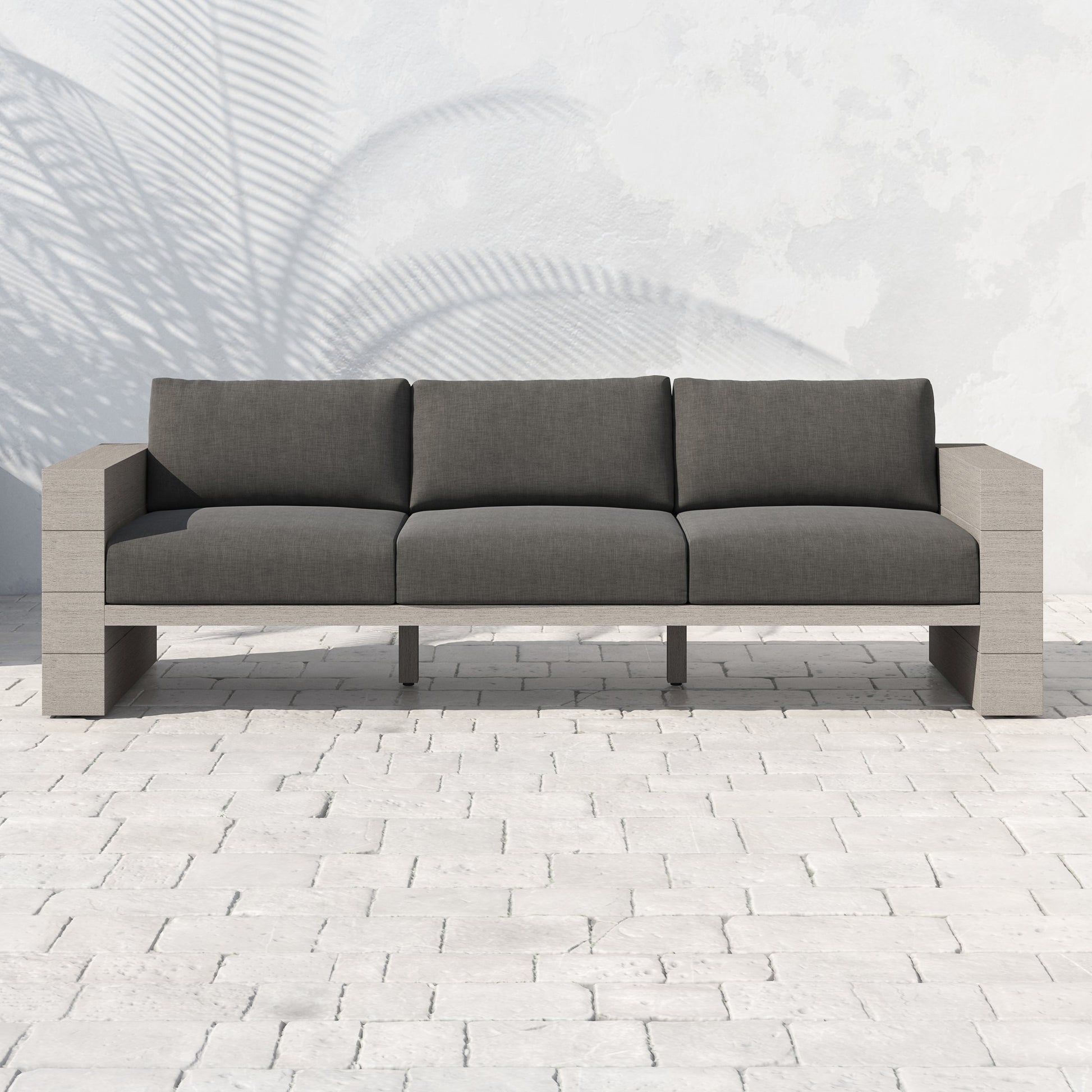 Leroy Outdoor Sofa by Four Hands. Made from 100% olefin, solid teak, 91% polyurethane foam pad, 9% polyester fiber batting in a coastal style.