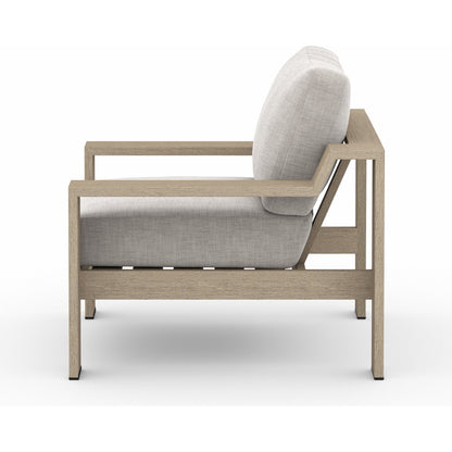Monterey Outdoor Chair by Four Hands in stone gray, washed brown. Made from 100% olefin, solid fsc®-certified teak, 59% polyurethane foam, 30% polyester fiber, 11% polyester fiber batting in a coastal style.