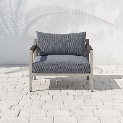 Sherwood Outdoor Chair, Weathered Grey by Four Hands. Made from 100% olefin, solid fsc®-certified teak, 100% polypropylene in a coastal style.