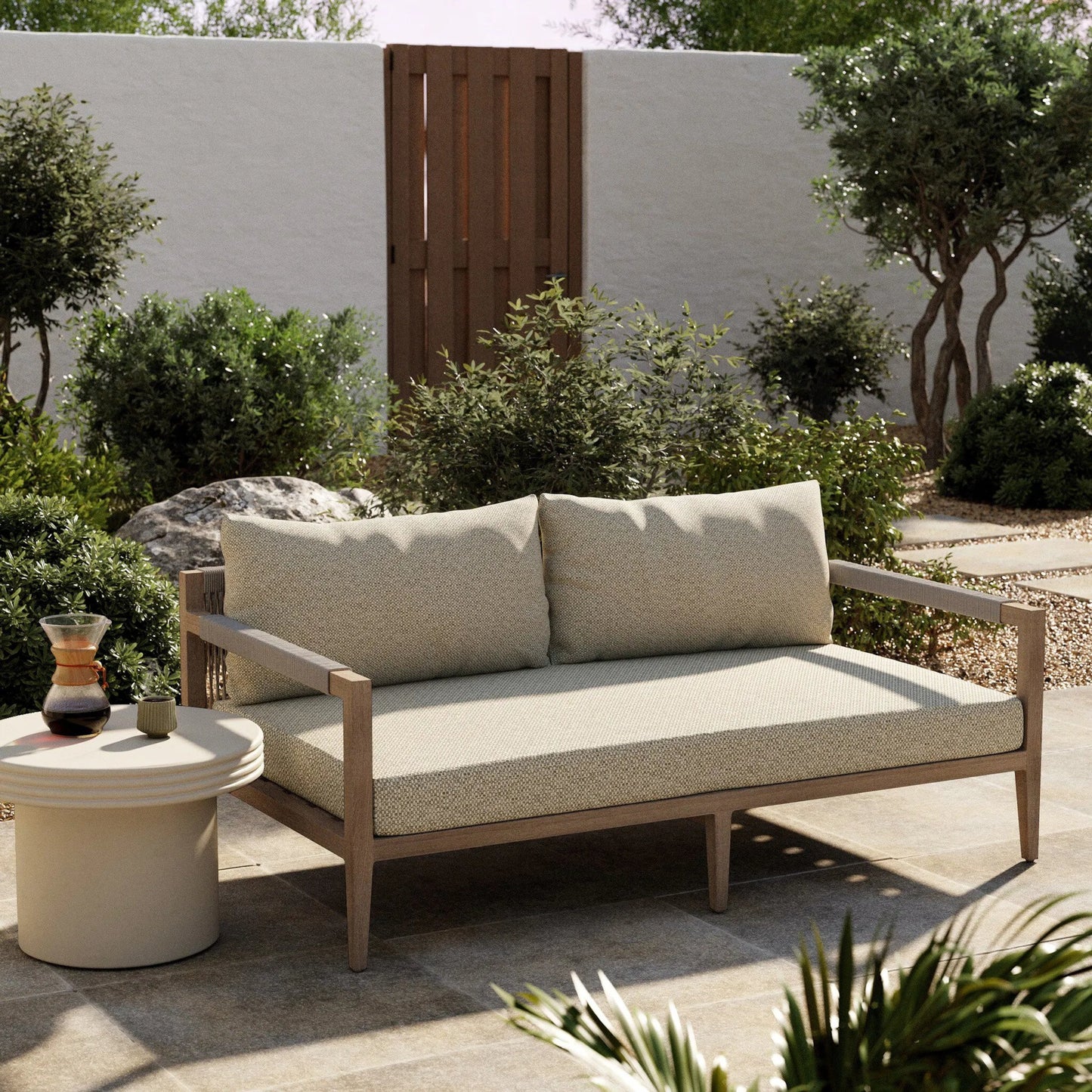 176 SR-713001 | Lifestyle | Sherwood Outdoor Sofa, Washed Brown by Four Hands. Made from 100% olefin, solid fsc®-certified teak, 100% polypropylene in a coastal style.