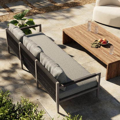 Sherwood Outdoor Sofa, Weathered Grey by Four Hands. Made from 100% olefin, solid fsc®-certified teak, 100% polypropylene in a coastal style.