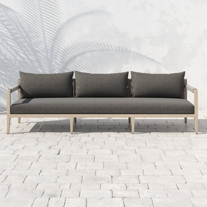 Sherwood Outdoor Sofa, Washed Brown by Four Hands. Made from 100% olefin, solid fsc®-certified teak, 100% polypropylene in a coastal style.