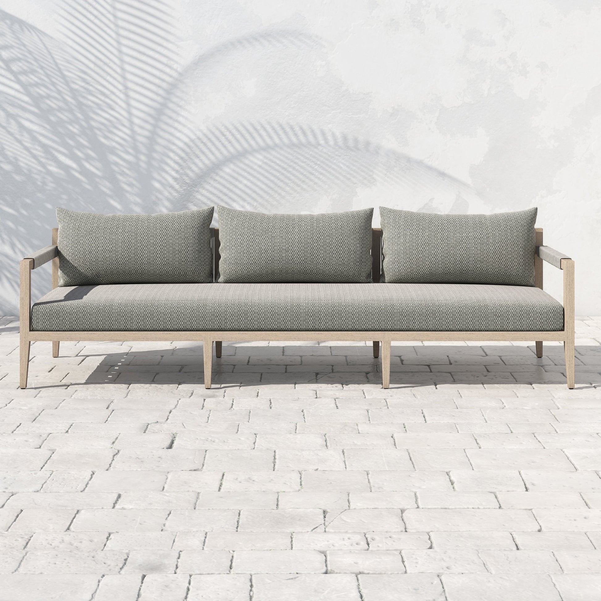 Sherwood Outdoor Sofa, Washed Brown by Four Hands. Made from 100% olefin, solid fsc®-certified teak, 100% polypropylene in a coastal style.
