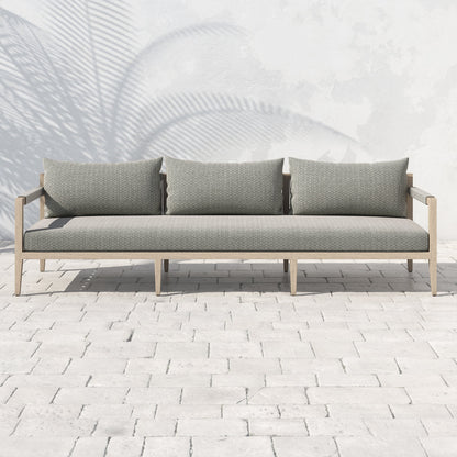 Sherwood Outdoor Sofa, Washed Brown by Four Hands. Made from 100% olefin, solid fsc®-certified teak, 100% polypropylene in a coastal style.