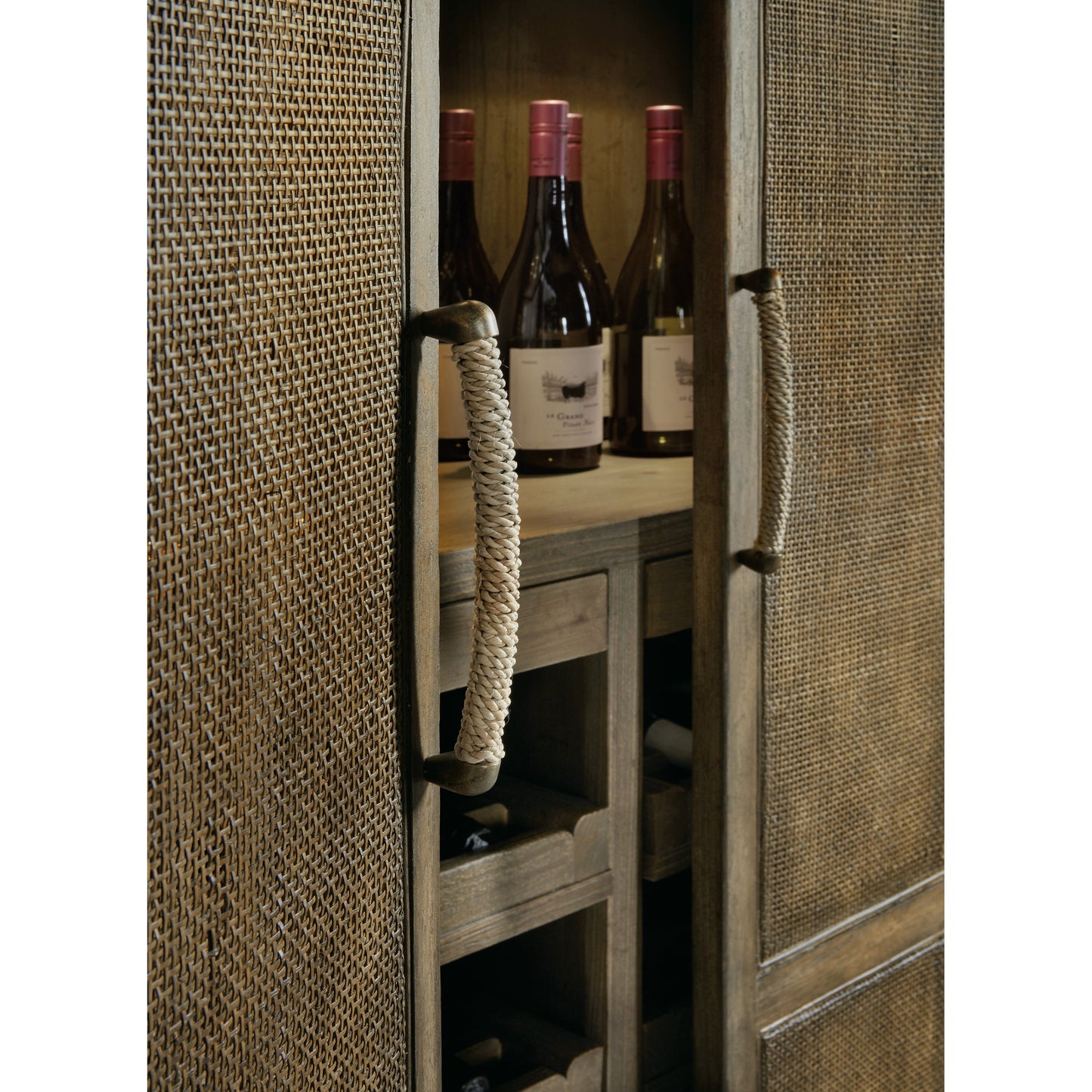 005 SI-1749788 | Closeup | Sundance Bar Cabinet by Hooker Furniture in cliffside. Made from pecan veneers, rattan, glass, puck light, self-closing undermount drawer guides in a transitional style.