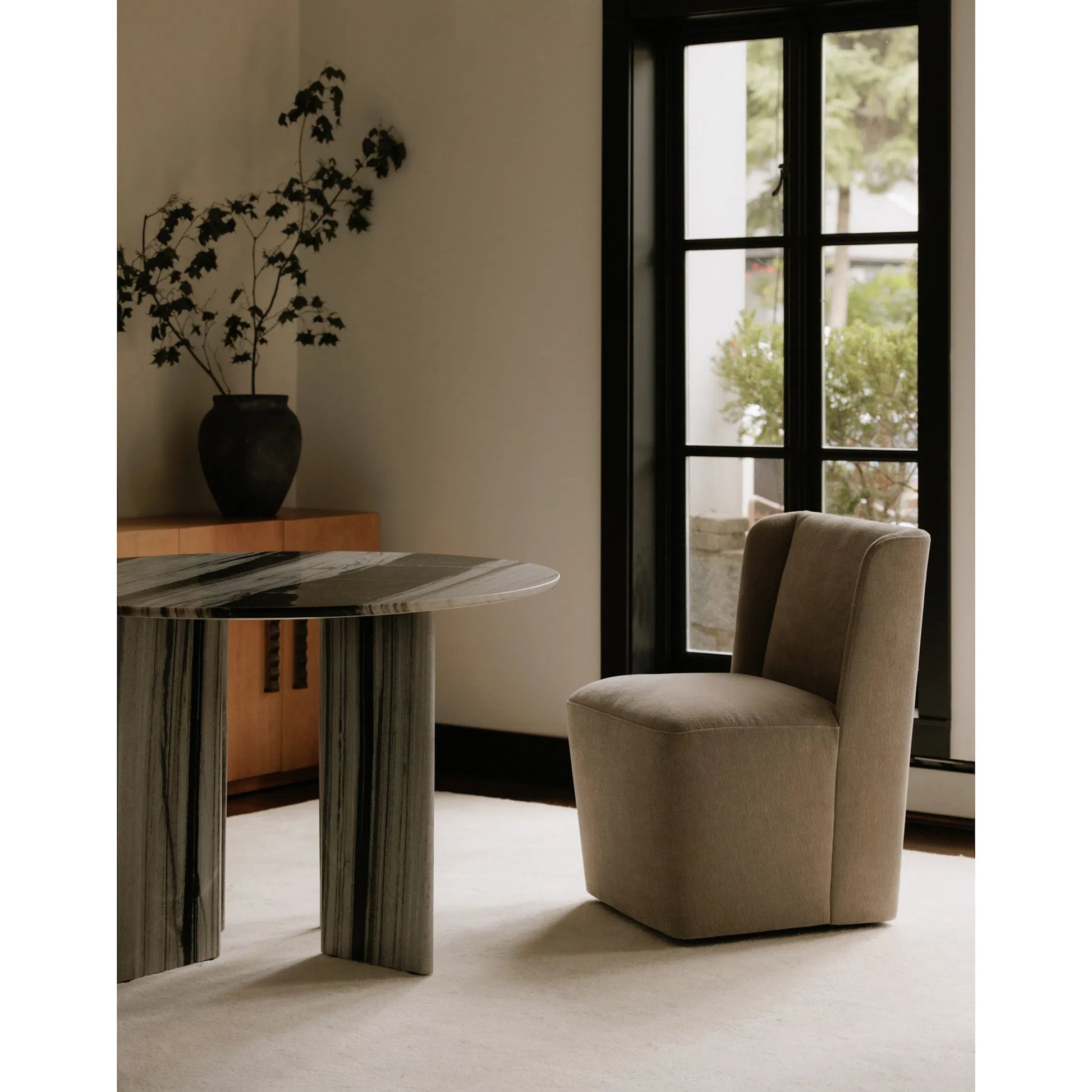 Cormac Rolling Dining Chair by Moe's Home Collection. Made from 100% polyester, poplar multi-layer board, laminated veneer lumber, high density foam, metal wheels in a transitional style.