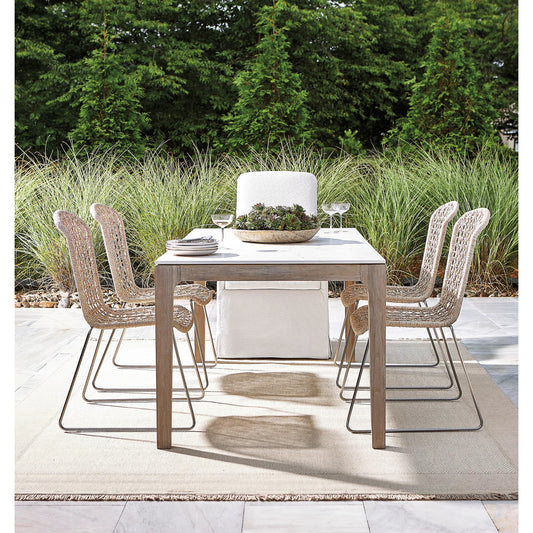 Marbella Outdoor Dining Table by Bernhardt in matte white shell, sun-washed. Made from ultra-compact dekton, white shell, solid teak, stainless steel in a unique style.