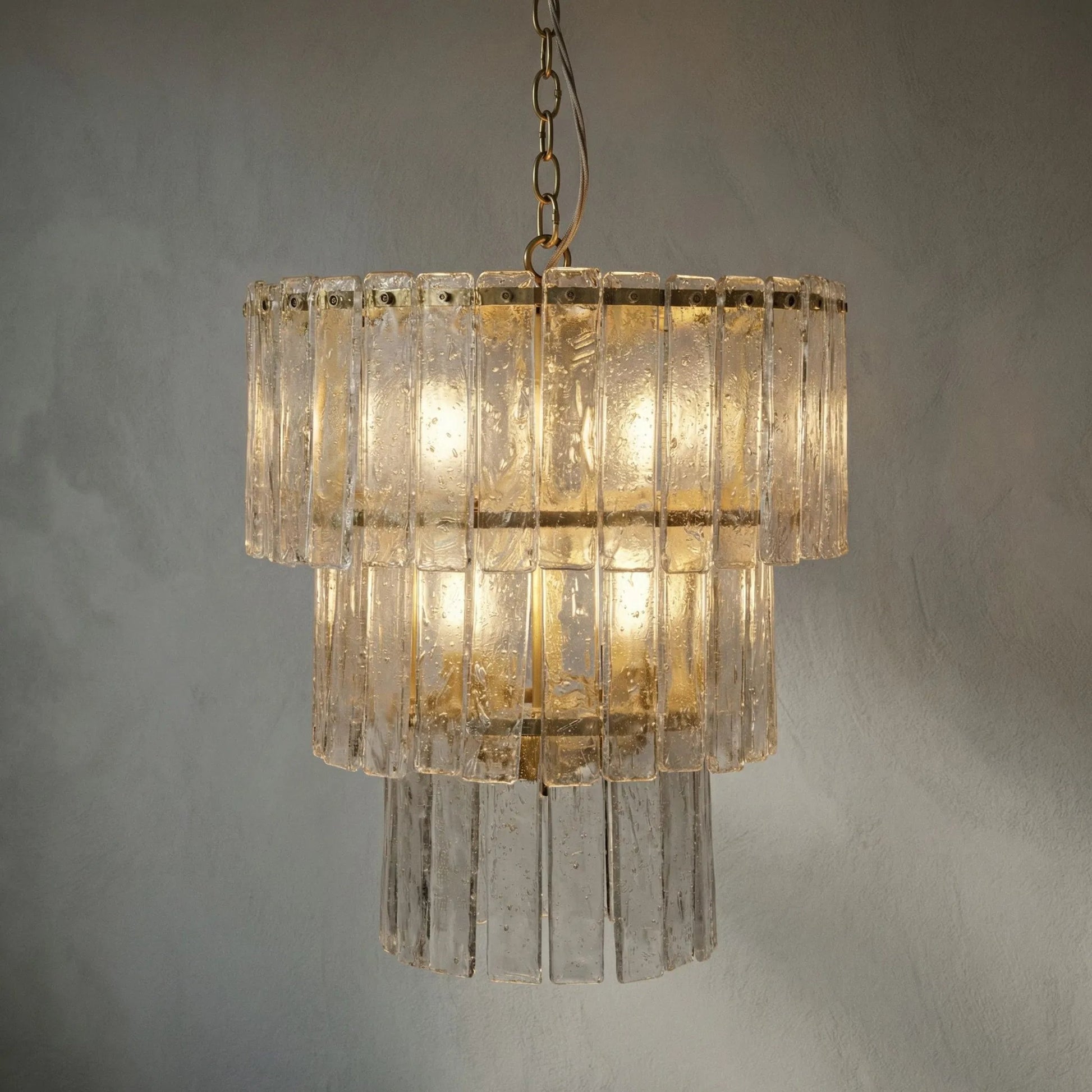 Bruna Chandelier by Noir in antique brass. Made from metal in a modern style.