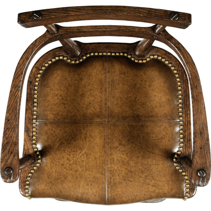 Casual Accents Tudor Oak Studded Leather Bar Stool by Jonathan Charles in brown and dark brown tudor oak. Made from oak in a rustic style.