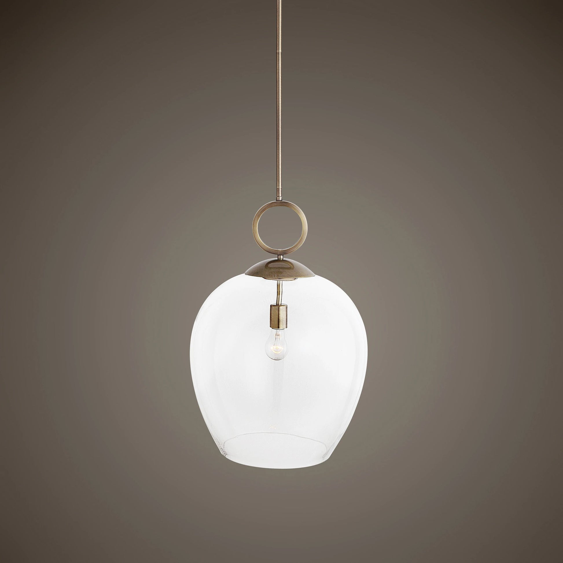Calix Pendant by Uttermost in aged brass. Made from steel, glass in a transitional style.