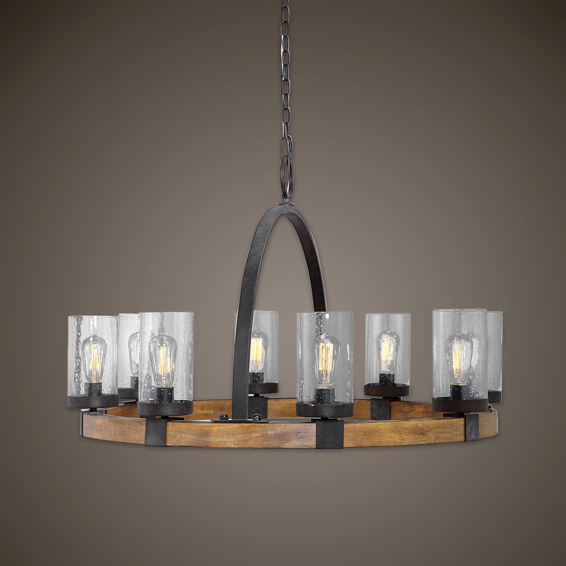 Atwood Wagon Wheel Pendant by Uttermost. Made from steel, rubber wood, glass in a rustic style.