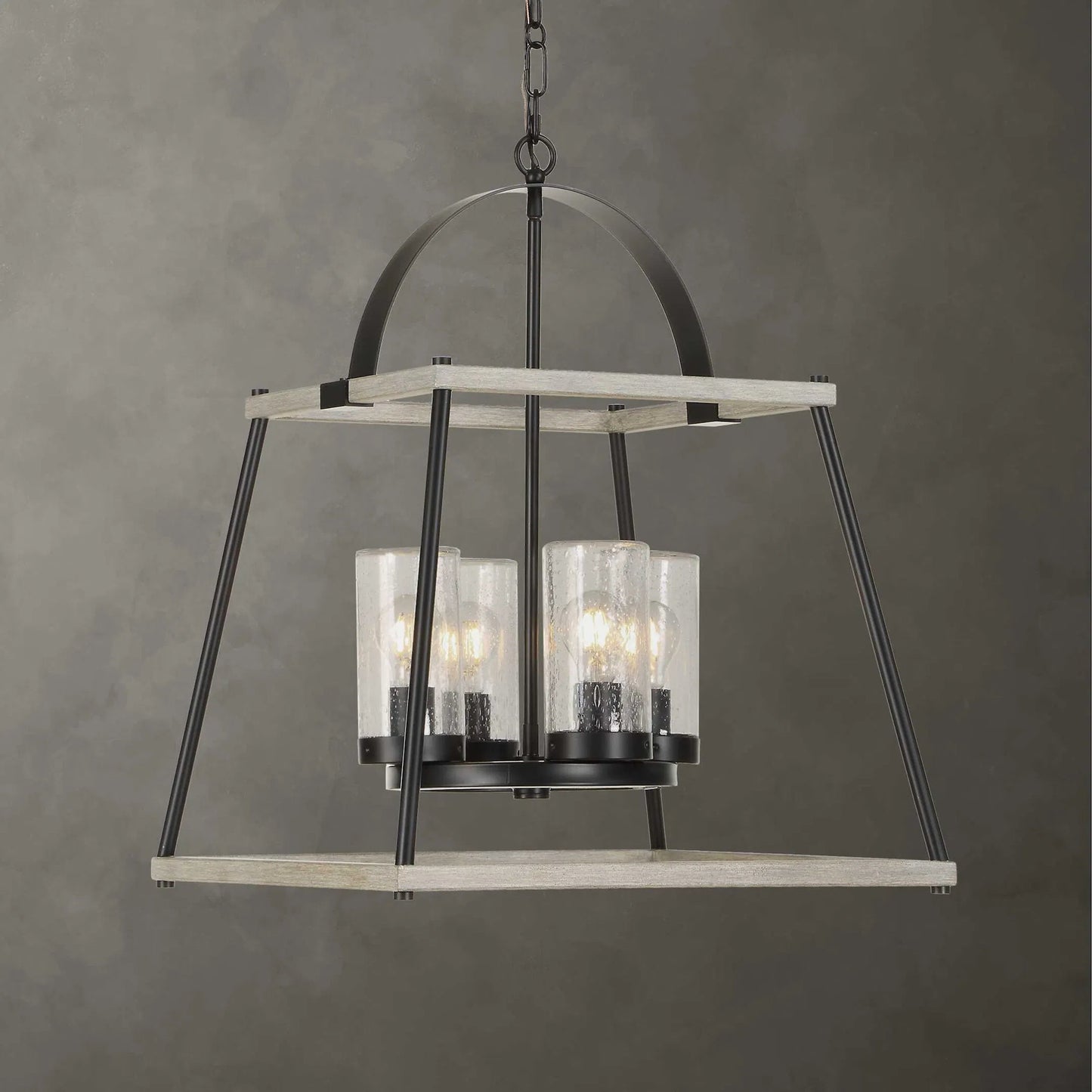 003 SI-2630600 | Lifestyle | Edgecomb 4 Light Indoor/Outdoor Pendant by Uttermost in black and black. Made from iron, clear seeded glass in a unique style.