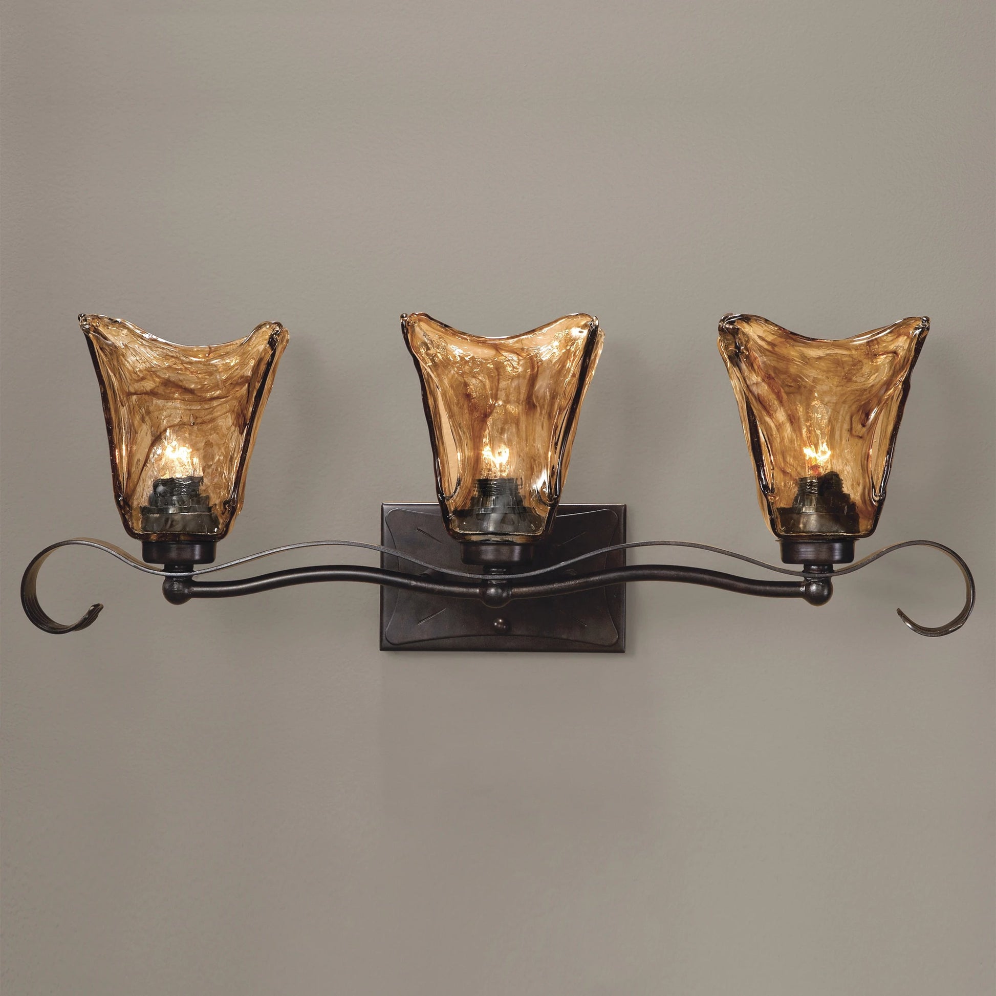 Vetraio Vanity Strip by Uttermost in bronze. Made from metal, brass, glass in a rustic style.