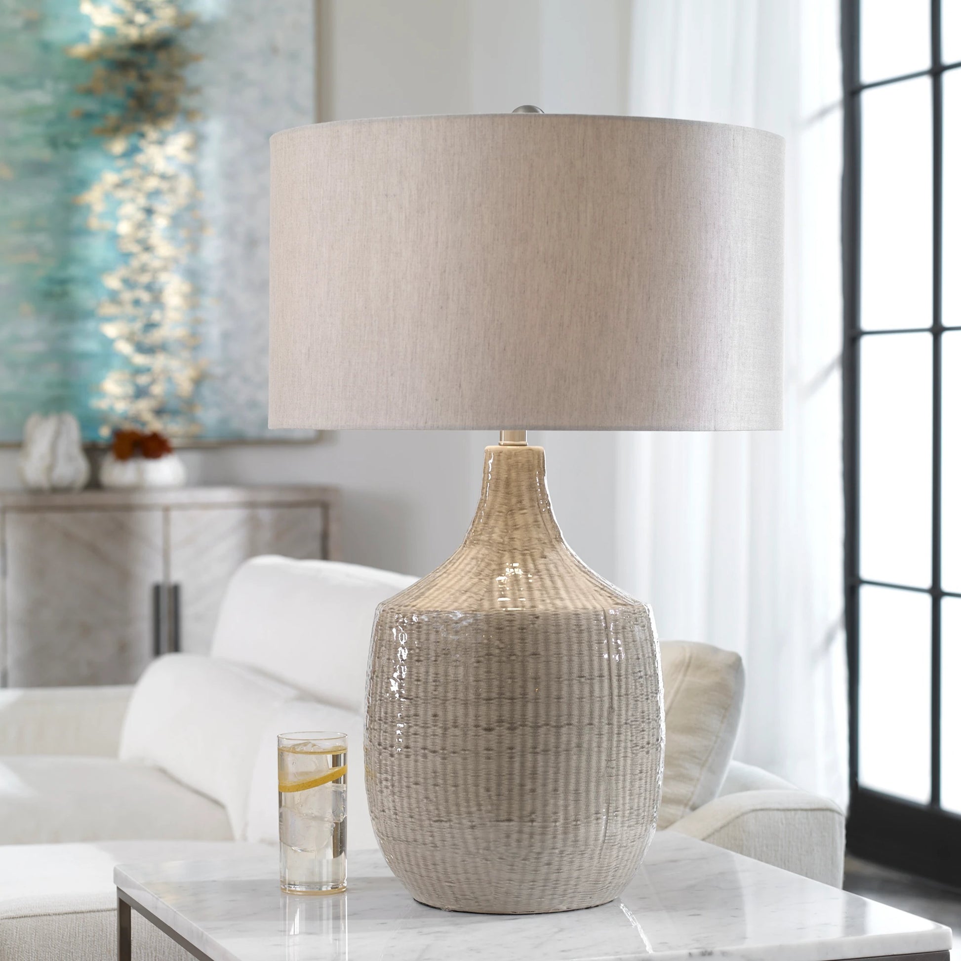 Felipe Table Lamp by Uttermost in light gray. Made from ceramic, iron, fabric in a eclectic & global style.