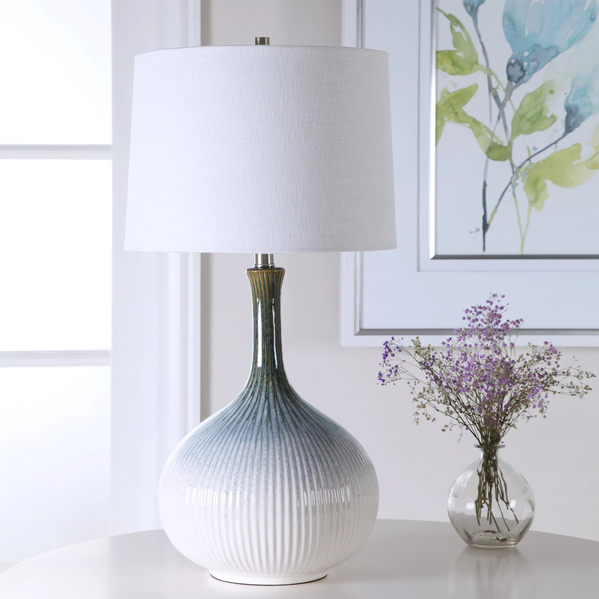 Eichler Mid-Century Table Lamp by Uttermost. Made from ceramic, fabric, iron in a coastal style.