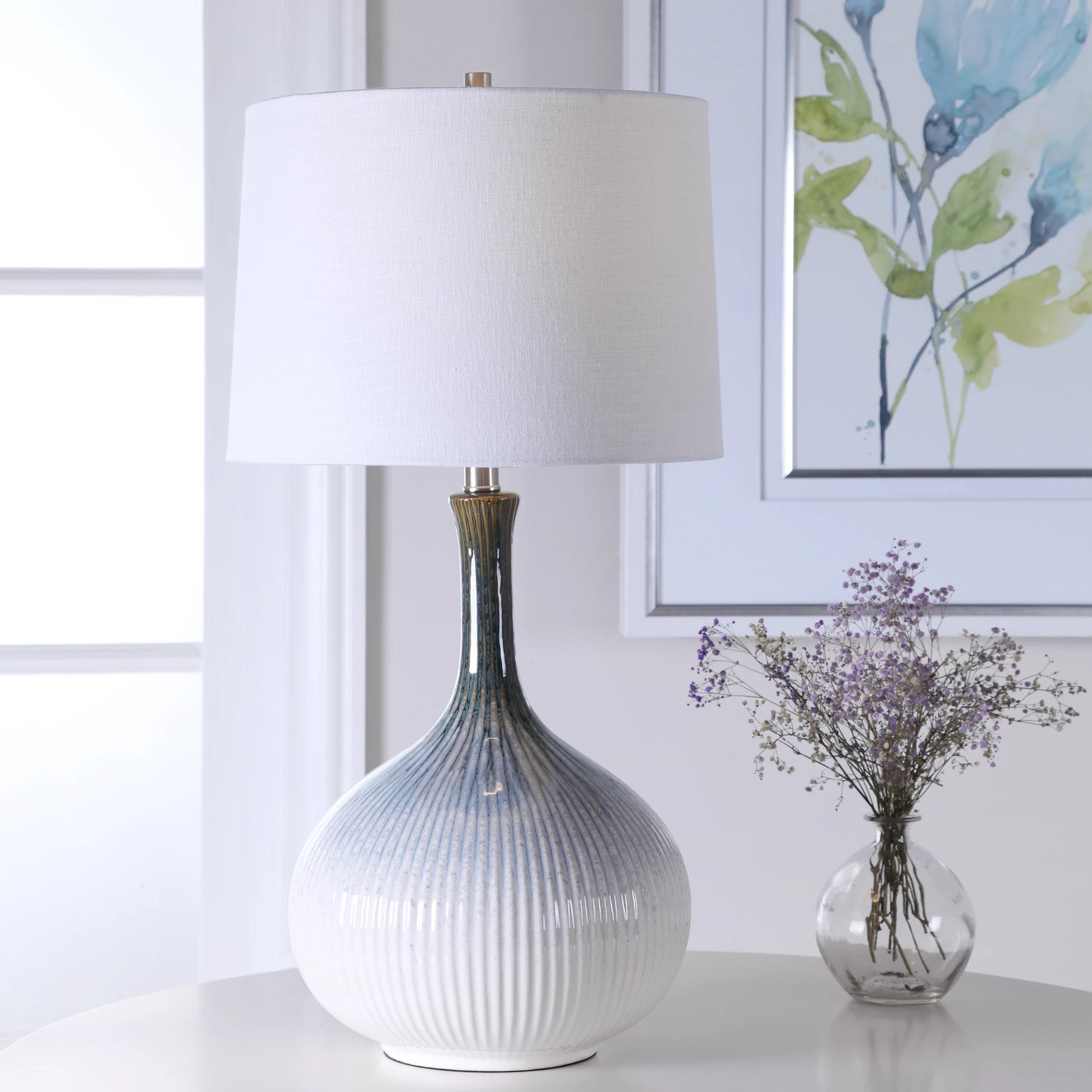 Eichler Mid-Century Table Lamp by Uttermost. Made from ceramic, fabric, iron in a coastal style.