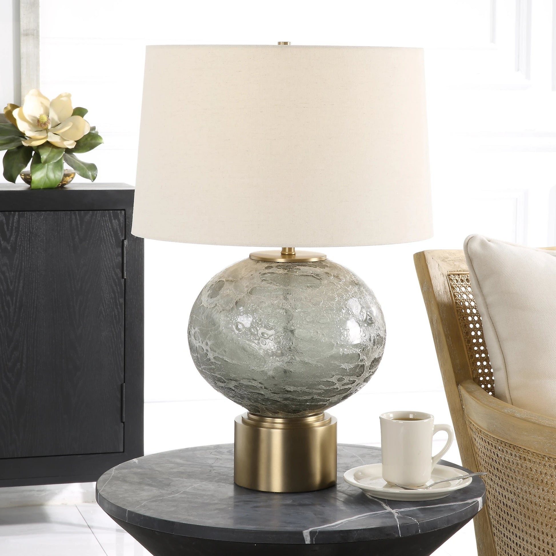 Lunia Table Lamp by Uttermost in smoky gray. Made from iron, glass, linen in a modern style.