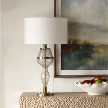 Out of Time Seeded Glass Table Lamp by Uttermost in brass. Made from iron, glass, fabric in a modern style.