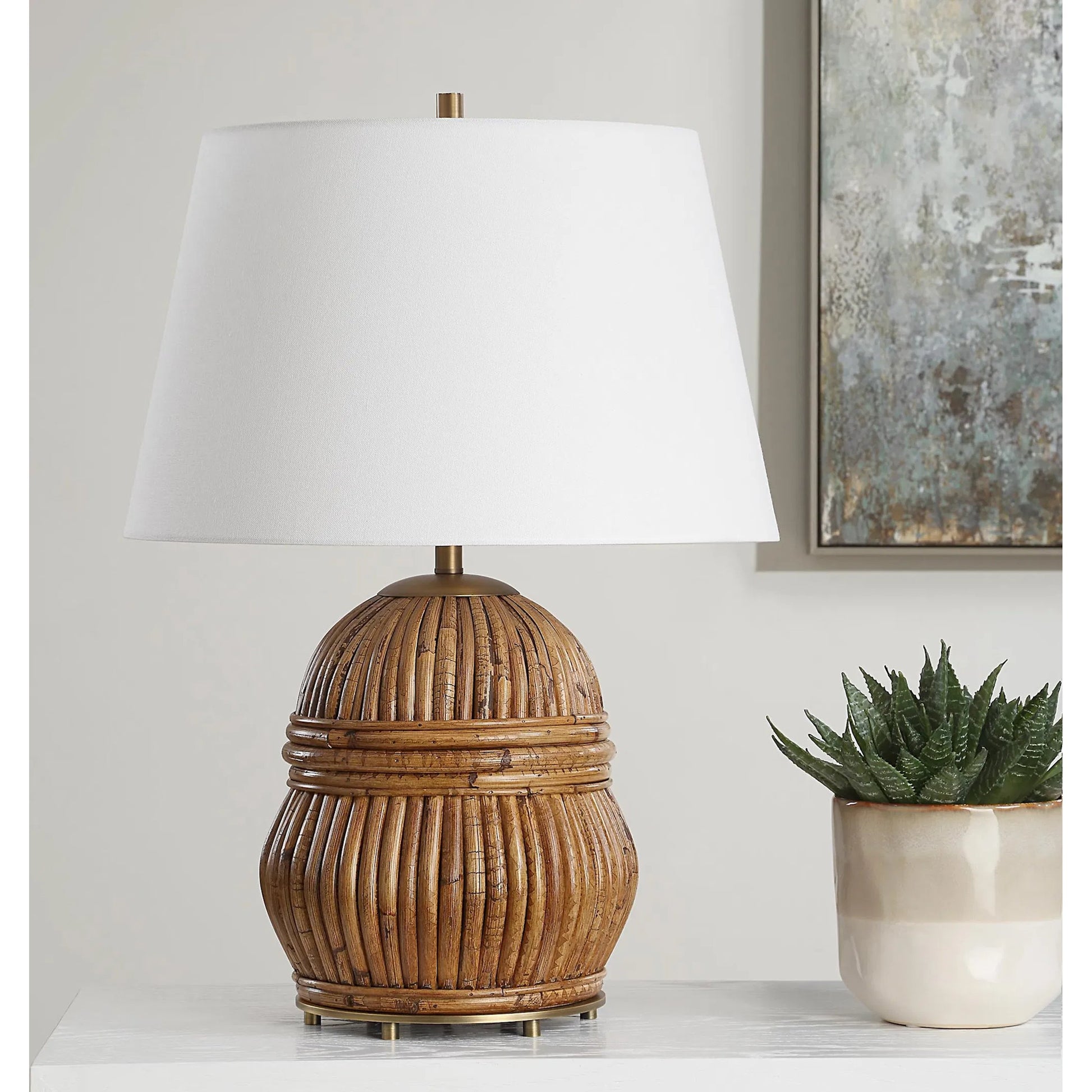 Reed Honey Rattan Table Lamp by Uttermost in brass. Made from steel, rattan, fabric in a rustic style.