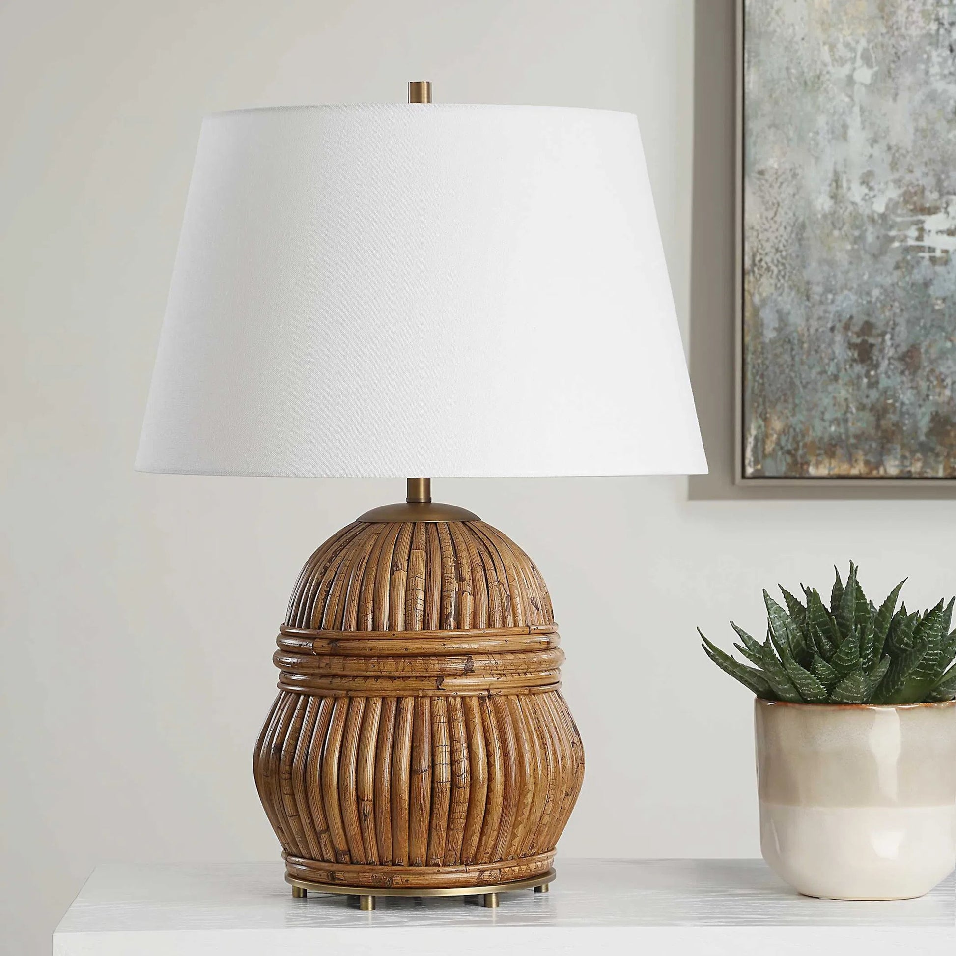 Reed Honey Rattan Table Lamp by Uttermost in brass. Made from steel, rattan, fabric in a rustic style.
