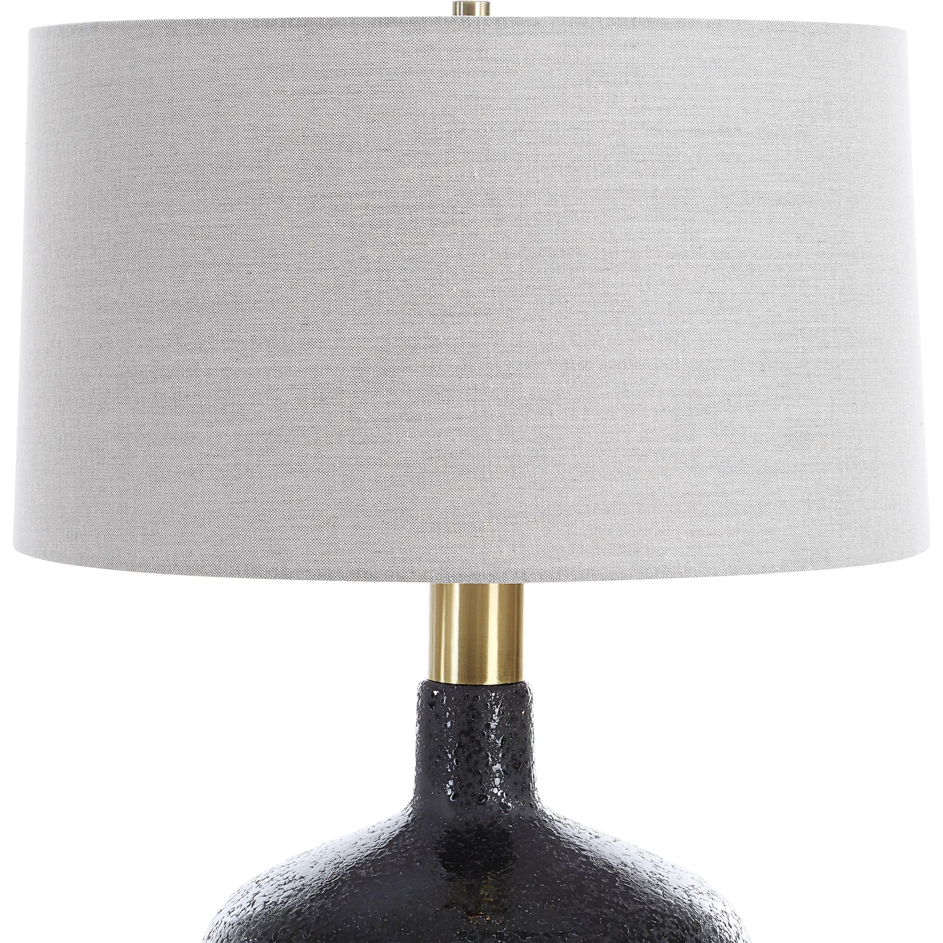Flanagan Mottled Gloss Table Lamp by Uttermost in brass. Made from steel, ceramic, fabric in a modern style.