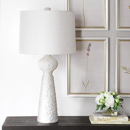 Sonata Textured Table Lamp by Uttermost in brass. Made from ceramic, steel, fabric in a transitional style.