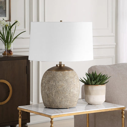 Raylan Textured Table Lamp by Uttermost in brass. Made from metal, cement, fabric in a modern style.