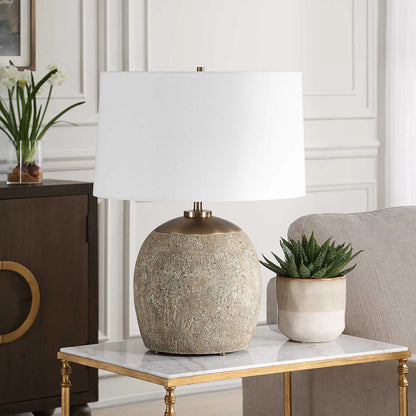 Raylan Textured Table Lamp by Uttermost in brass. Made from metal, cement, fabric in a modern style.