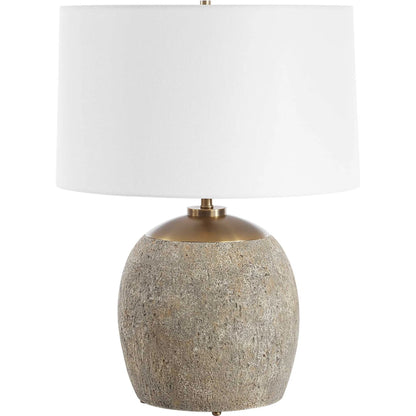 Raylan Textured Table Lamp by Uttermost in brass. Made from metal, cement, fabric in a modern style.
