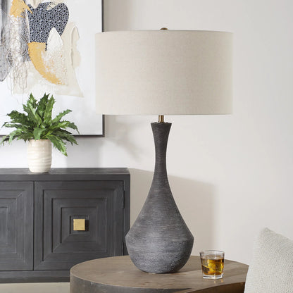 Helston Table Lamp by Uttermost in dark charcoal. Made from metal, ceramic, fabric in a modern style.
