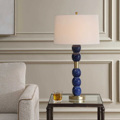 Bellore Glaze Table Lamp by Uttermost in blue and brass. Made from ceramic, iron, fabric in a unique style.