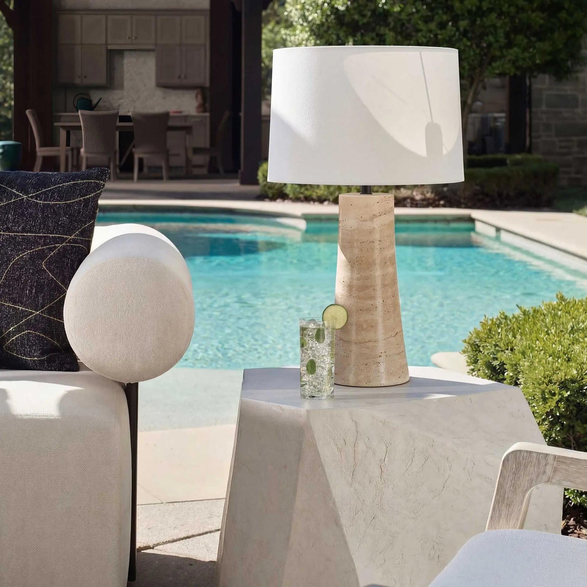 Delmani Indoor/Outdoor Lamp by Uttermost in dark. Made from travertine, iron, fabric in a unique style.
