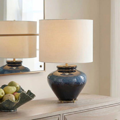 Andrus Glaze Table Lamp by Uttermost in blue and brass. Made from ceramic, fabric, iron in a unique style.
