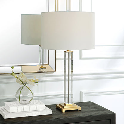 Crystal Column Table Lamp by Uttermost in brass. Made from crystal, iron, fabric in a modern style.