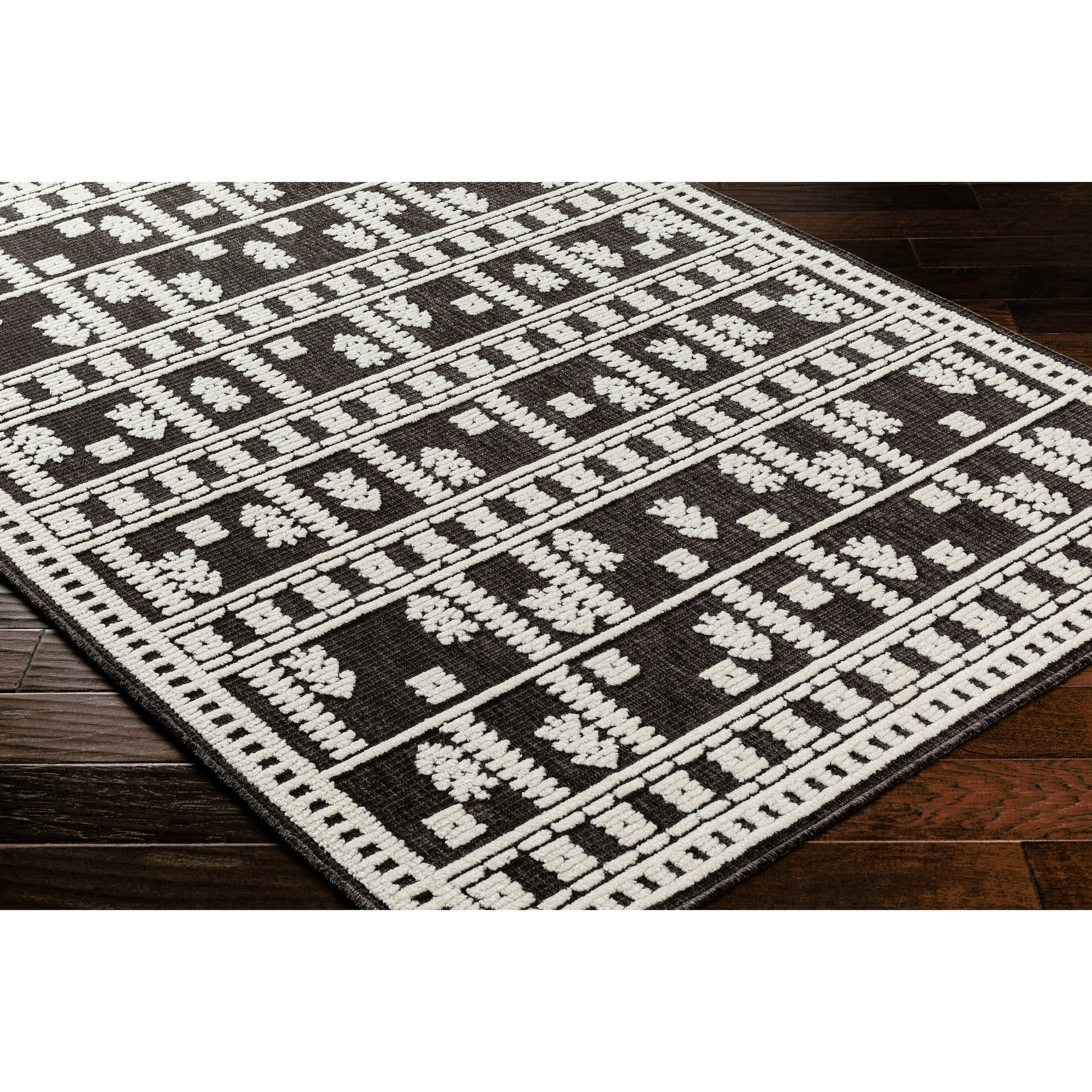 Lyna Rug by Livabliss in black, off-white. Made from main: 70% polypropylene, main: 30% polyester in a eclectic & global style.