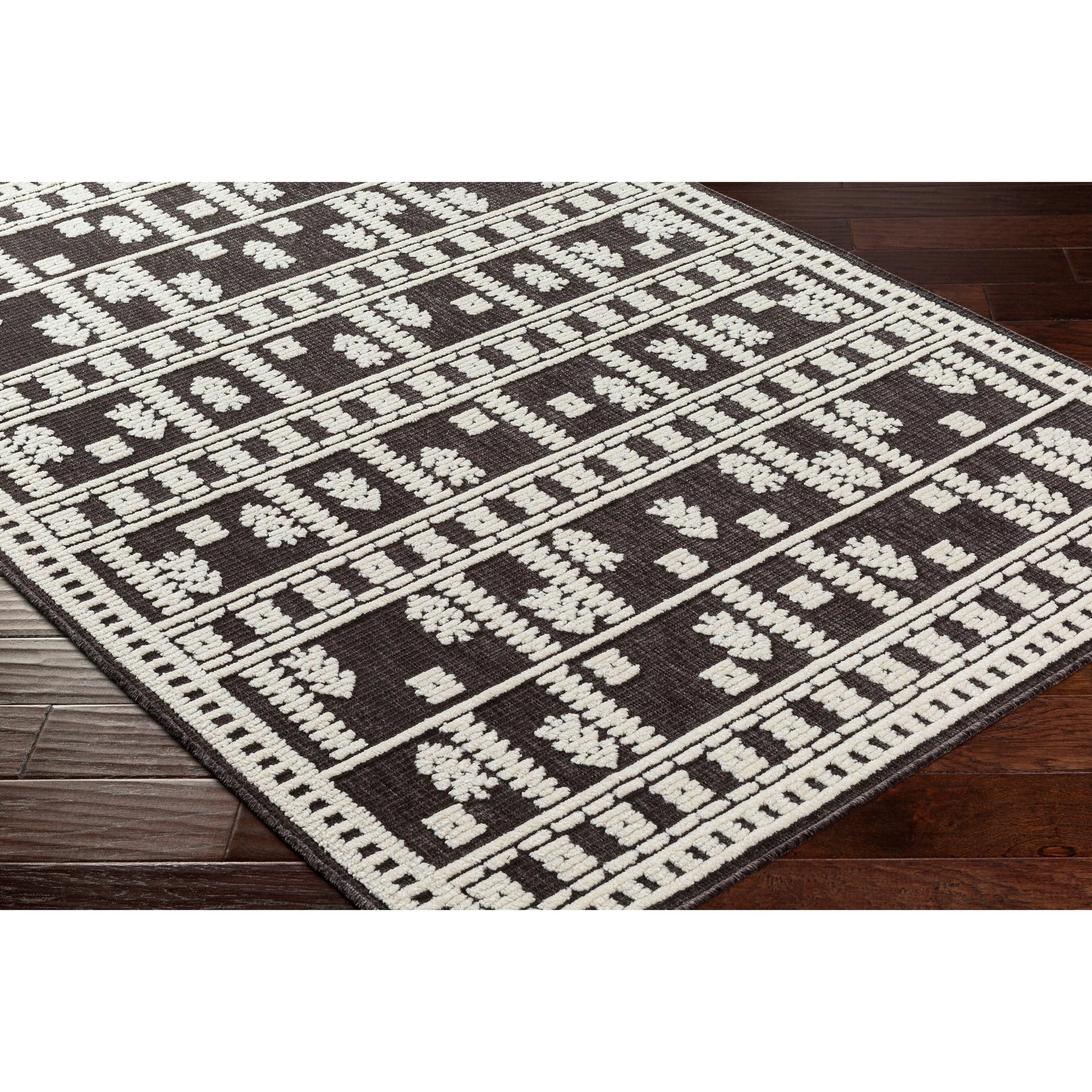 Lyna Rug by Livabliss in black, off-white. Made from main: 70% polypropylene, main: 30% polyester in a eclectic & global style.