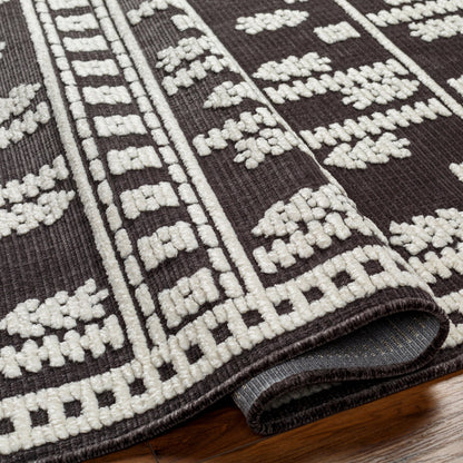 Lyna Rug by Livabliss in black, off-white. Made from main: 70% polypropylene, main: 30% polyester in a eclectic & global style.