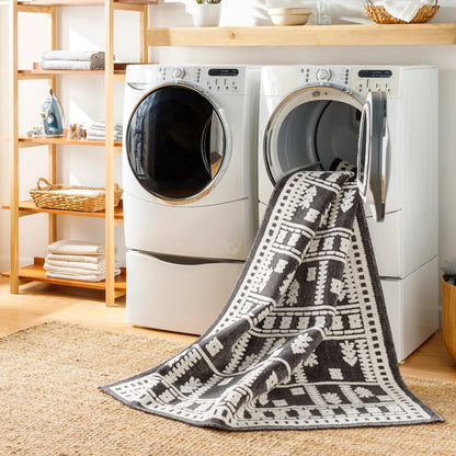 Lyna Rug by Livabliss in black, off-white. Made from main: 70% polypropylene, main: 30% polyester in a eclectic & global style.