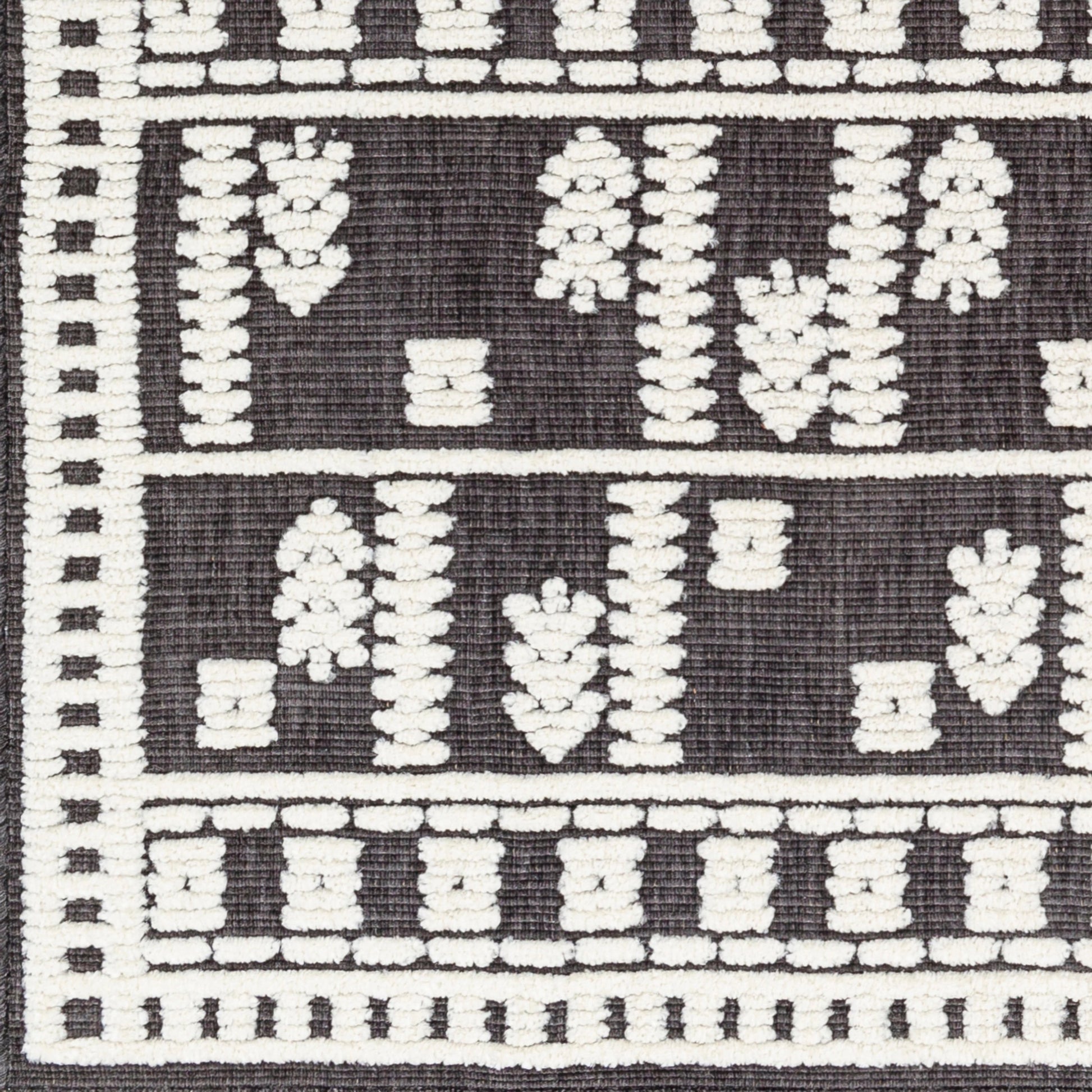 Lyna Rug by Livabliss in black, off-white. Made from main: 70% polypropylene, main: 30% polyester in a eclectic & global style.