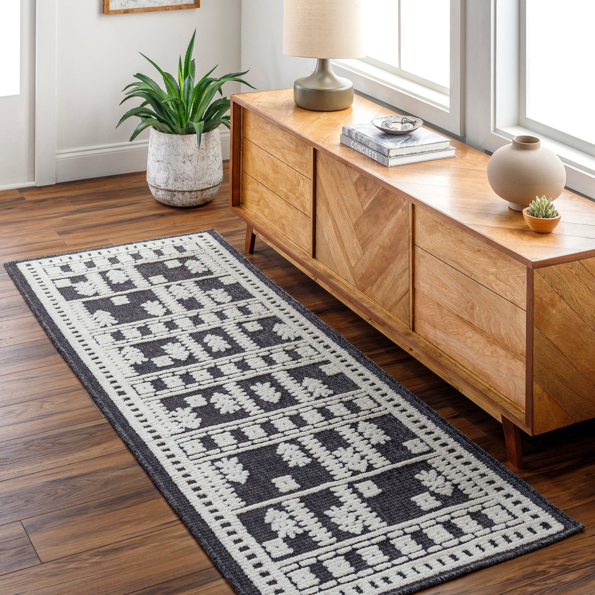 Lyna Rug by Livabliss in black, off-white. Made from main: 70% polypropylene, main: 30% polyester in a eclectic & global style.