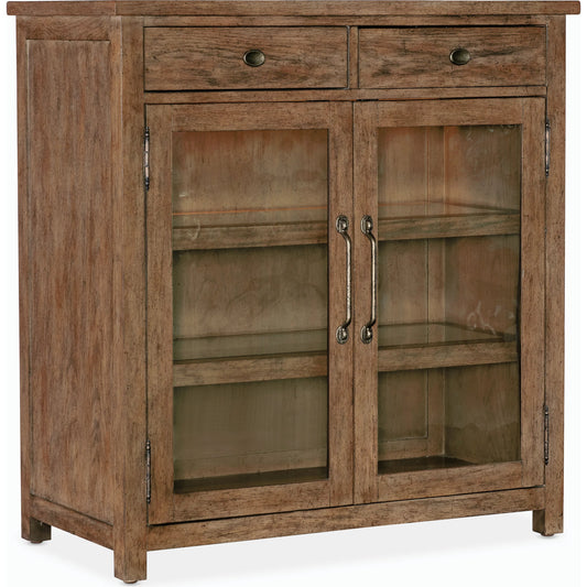 Americana Pie Chest by Hooker Furniture in brown and honey finish. Made from oak veneer with light, seeded glass and tempered glass in a modern style.