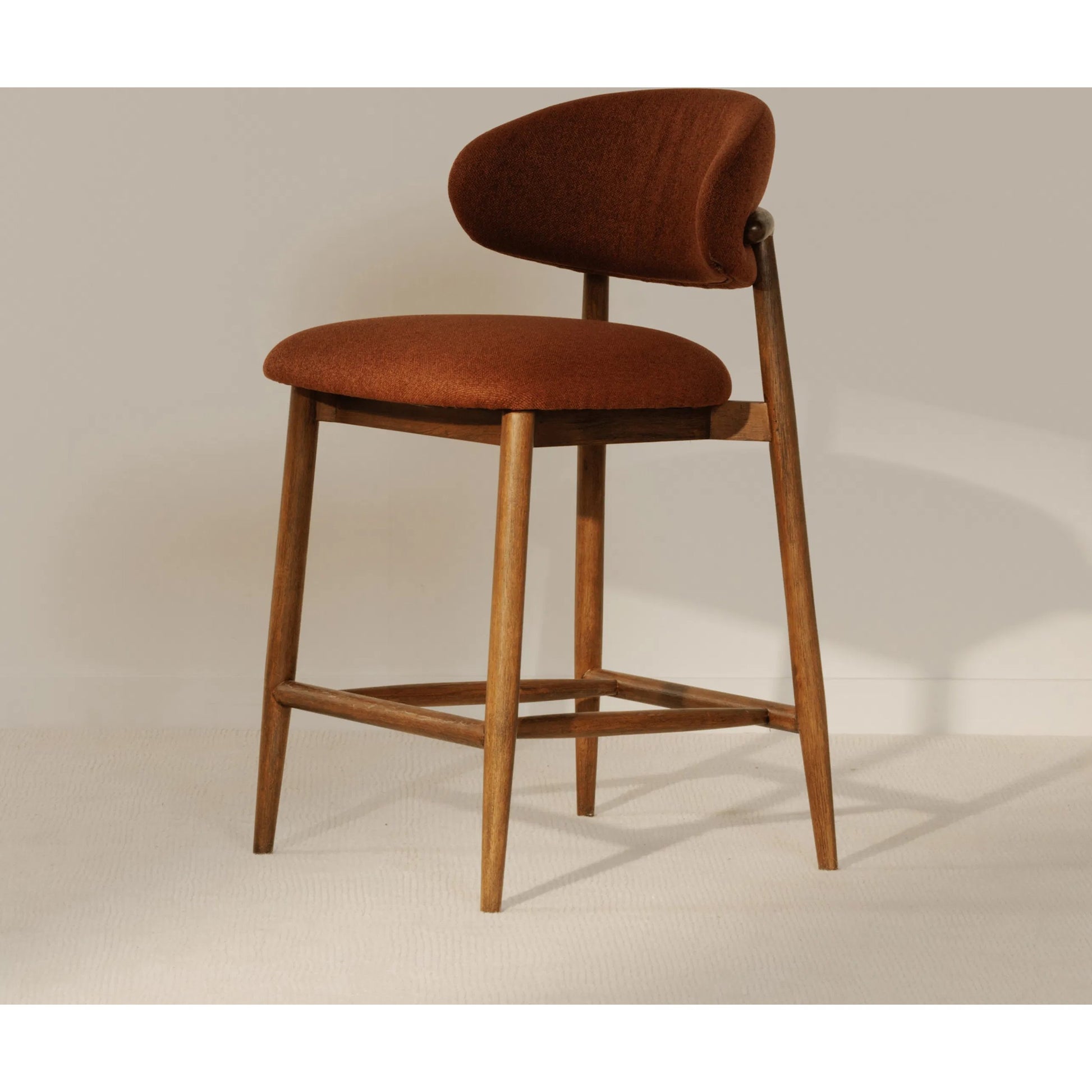 Ellie Counter Stool by Moe's Home Collection. Made from upholstery: 100% polyester, rubber wood frame, plywood in a transitional style.