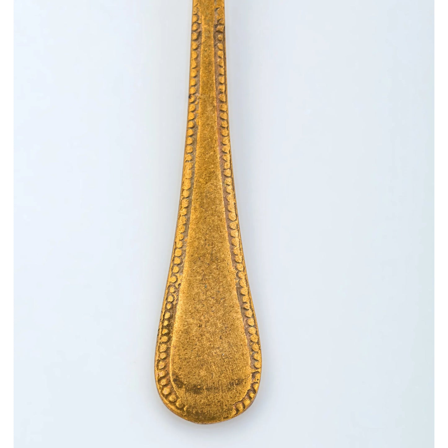 002 SI-2544504 | Closeup | Anuja Serving Spoon by TOV Furniture. Made from brass in a unique style.