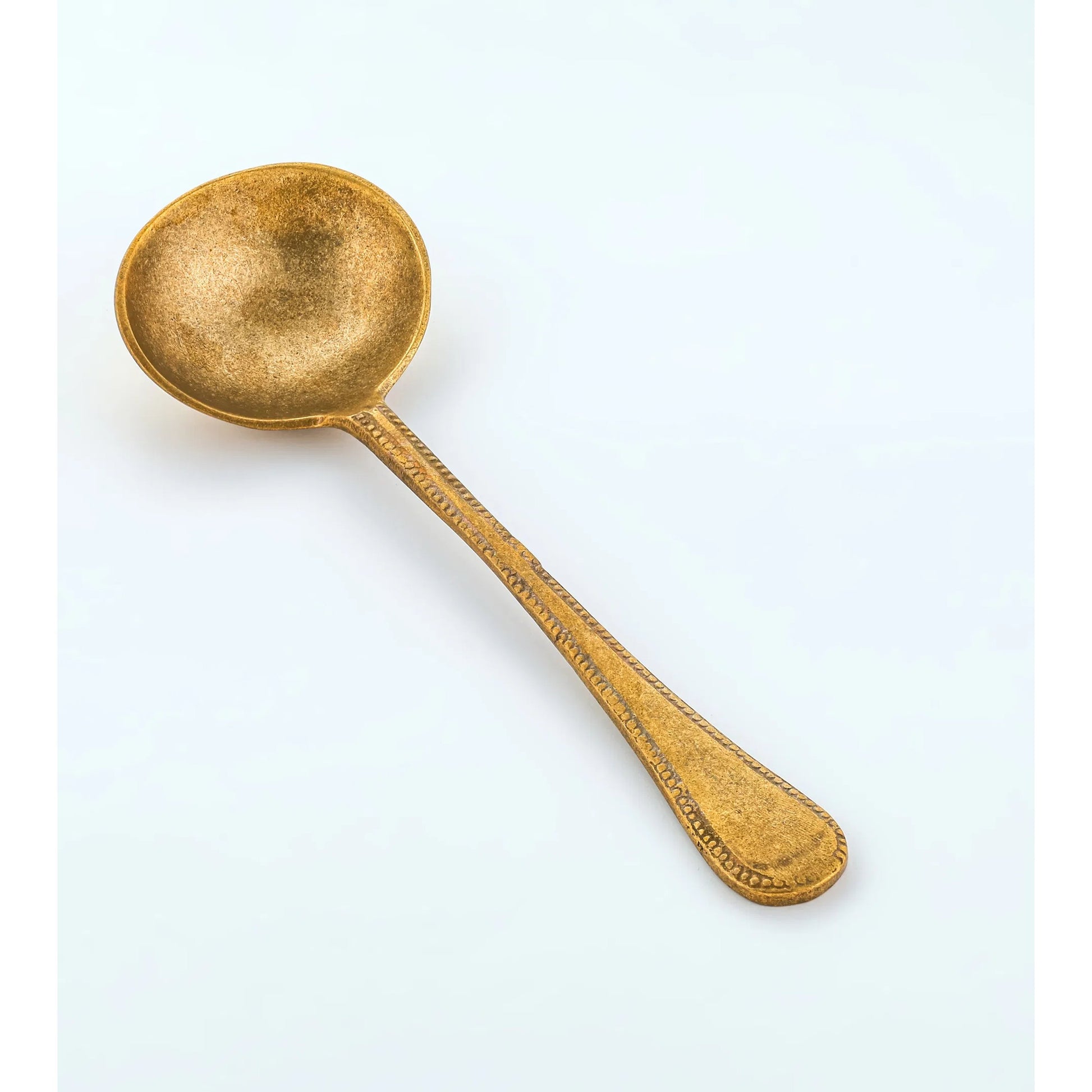 Anuja Serving Spoon by TOV Furniture. Made from brass in a unique style.
